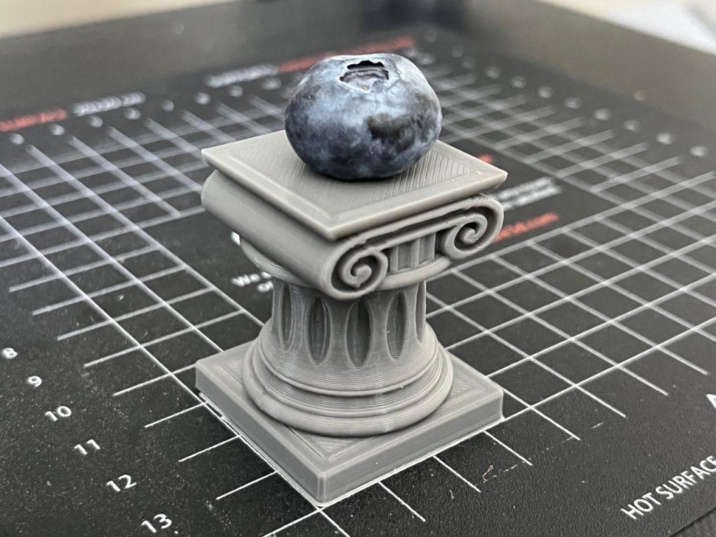 3D Printed Mini Ionic Column with a blueberry displayed on top